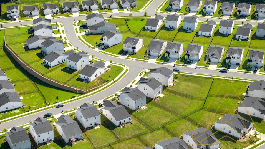 AXANH capabilities in subdivision in the USA: modern houses, green lawns, and winding streets.