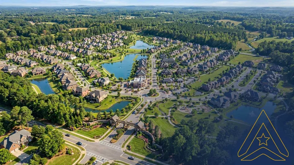 Aerial view of a suburban neighborhood with lakes, roundabout, forests. Logo of AXANH.