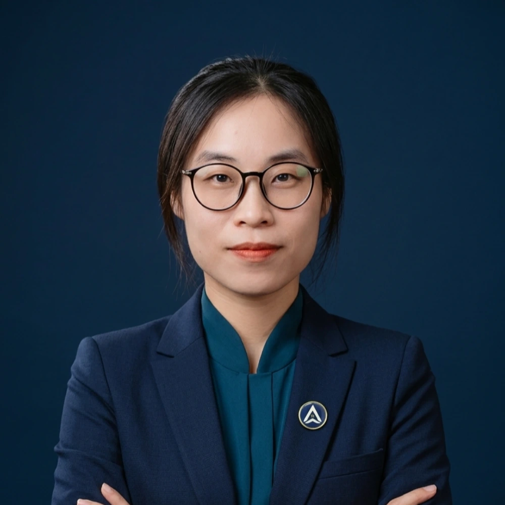 AXANH team member with glasses and dark hair, in blazer and shirt.