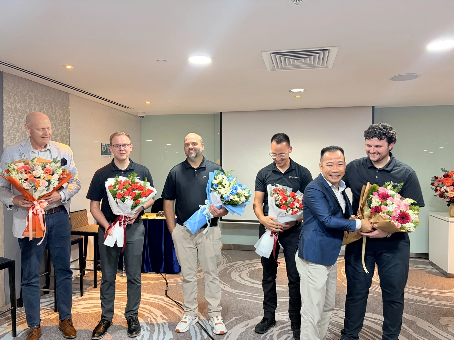 Participants receiving flowers following the AXANH and Utah Valley University MBA presentation.
