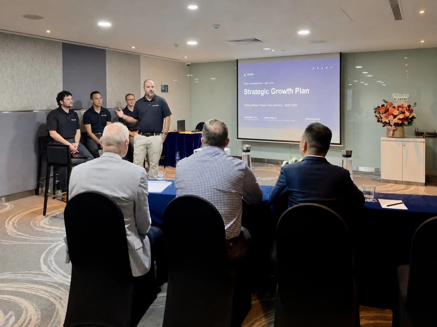 Man presenting Strategic Growth Plan to seated professionals in a conference room.