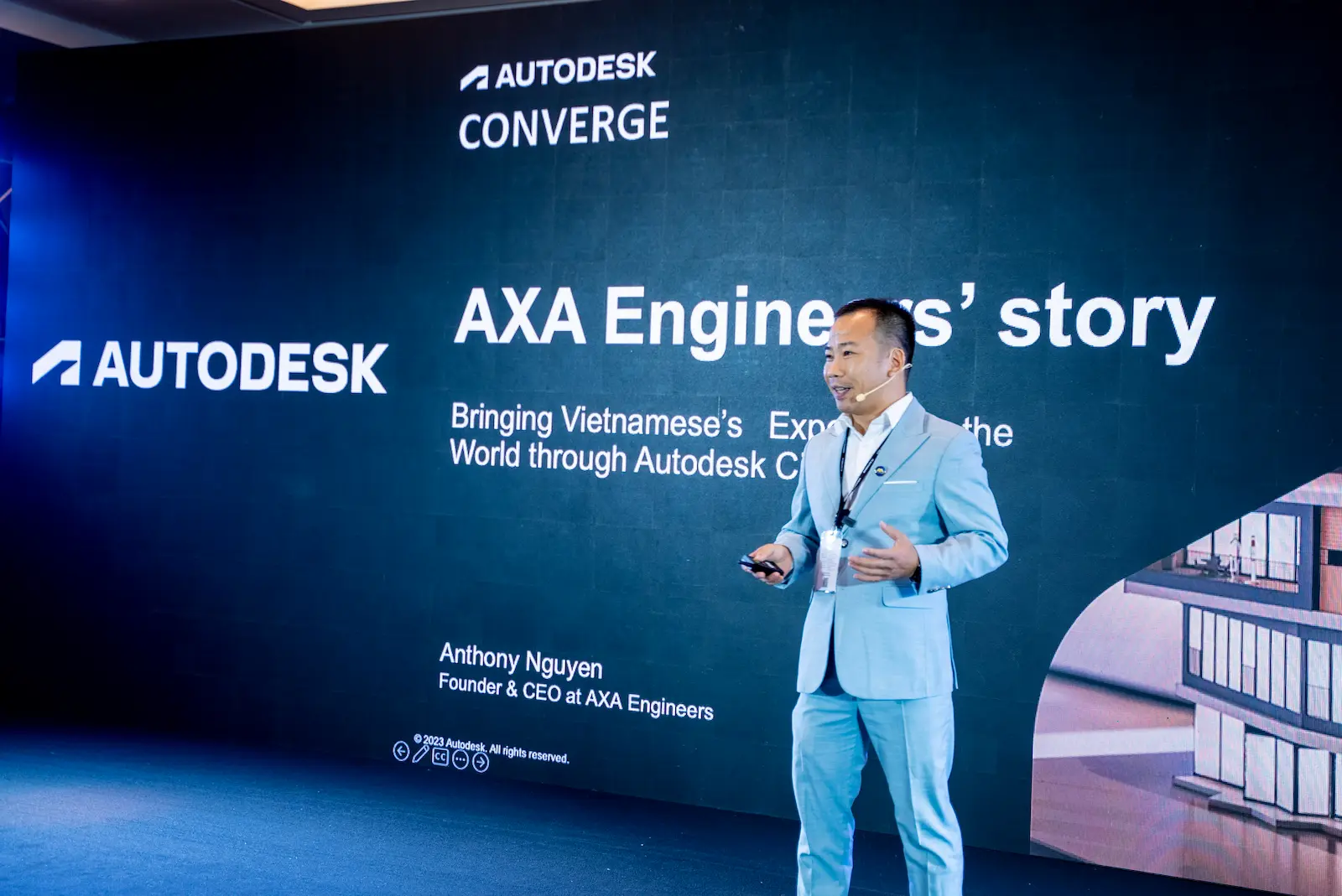 Anthony Nguyen speaking on stage at an Autodesk Converge presentation.